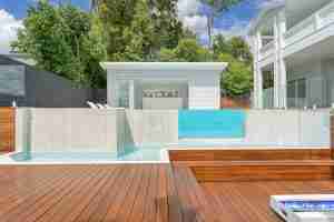 2023 SPASA award-winning innovative project by Ecozen Pools featuring a custom-designed infinity edge pool with a fully tiled heated spa overlooking city views, symbolising luxury and style - poolquotes.com.au