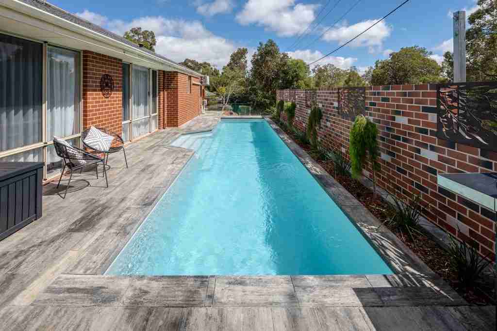 2023 SPASA award-winning fibreglass lap pool by Freedom Pools & Spas, featuring a 12m pool with smart phone connectivity for easy control, installed in a limited space site in WA, Australia.