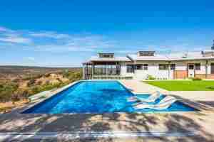 2023 SPASA award-winning vinyl lined in-ground pool by Add A Splash Pools in Perth Hills, perfect family oasis with stunning valley backdrop