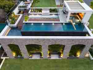 2023 WA Best Pool of the Year award winner by Graziani Pools + Landscape, featuring a luxurious 20 lineal metre infinity edge pool, wading deck, overflow pool and koi ponds, beautifully illuminated by 25.5 lineal metres of strip lighting on the external walls.